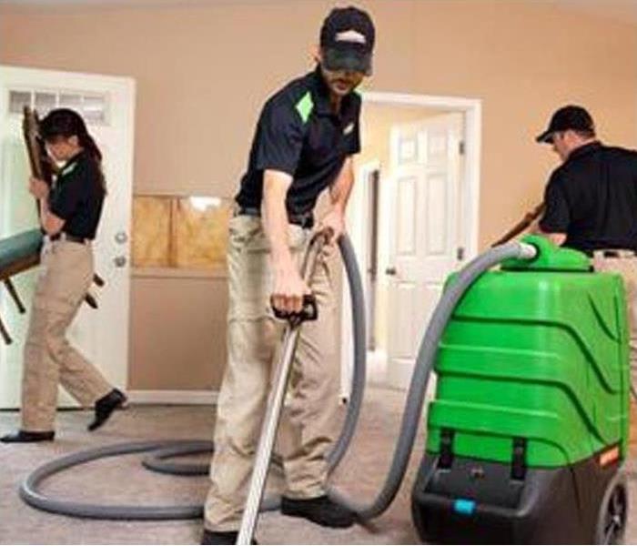 SERVPRO Technicians cleaning a room with equipment